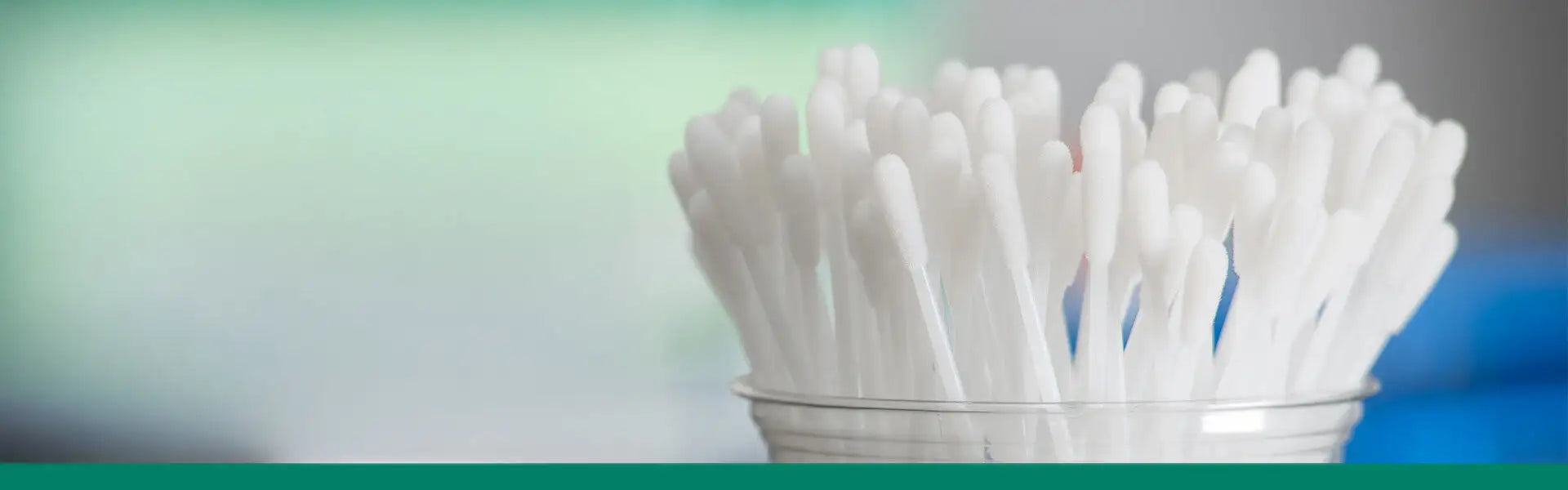 Jar of cotton swabs on a gradient background
