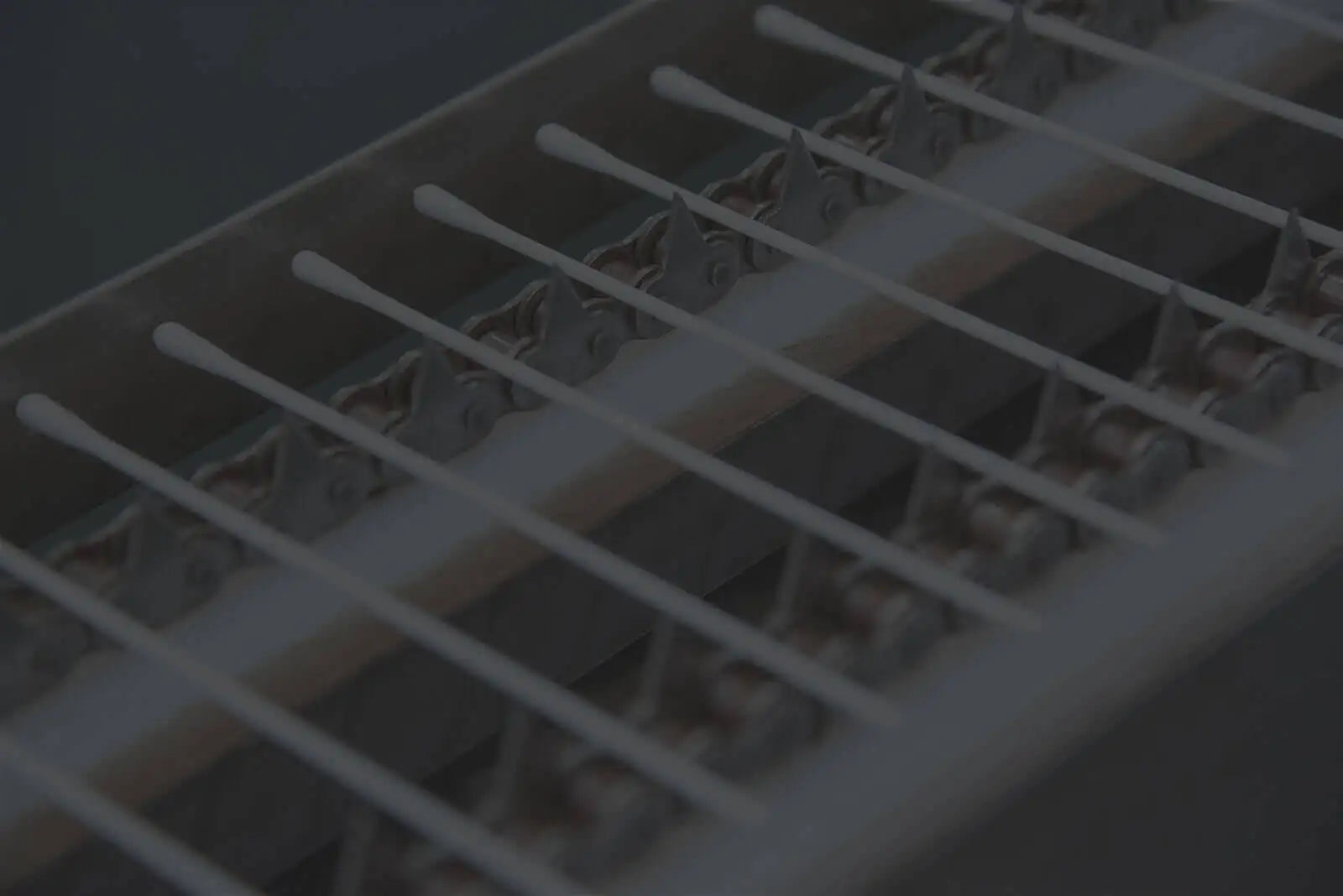 Close-up of a white plastic grid with small holes